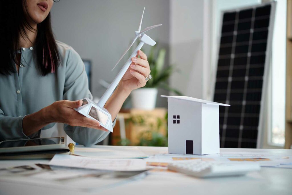 Sustainable energy company manager creating model to present customer at meeting